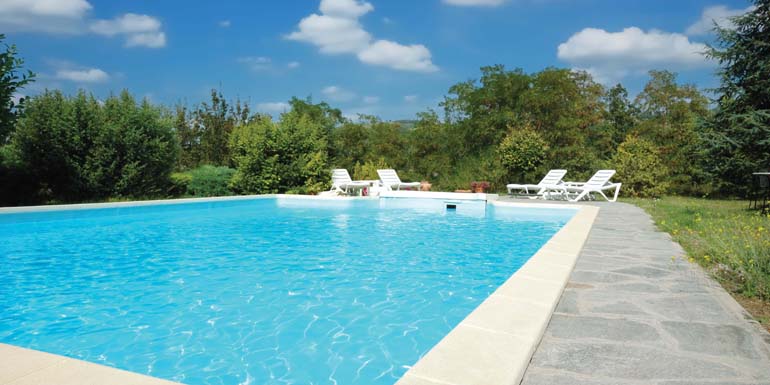 Swimming pool in the garden of an italian luxury villa, sunny day