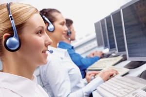 Row of telephone operators looking at the monitor and working