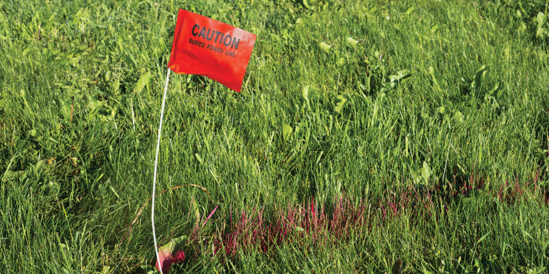 http://www.dreamstime.com/royalty-free-stock-photos-digger-hotline-flag-buried-electrical-power-line-red-red-paint-marks-path-people-can-call-to-have-utilities-image31579888