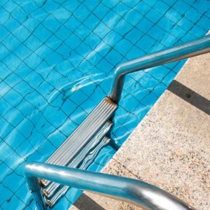 fragment of pool with a ladder and transparent water