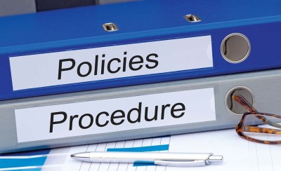 Policies and Procedure - two binders on desk in the office