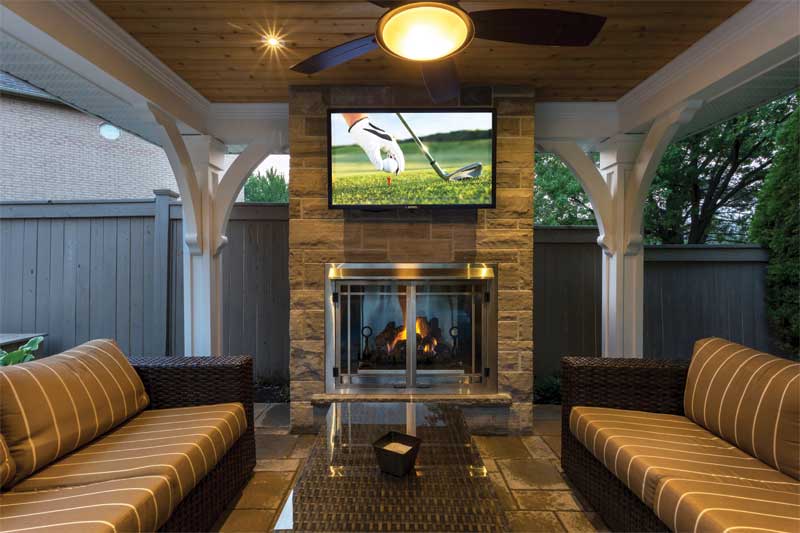 Landscaped backyard complete with an outdoor fireplace and sitting area