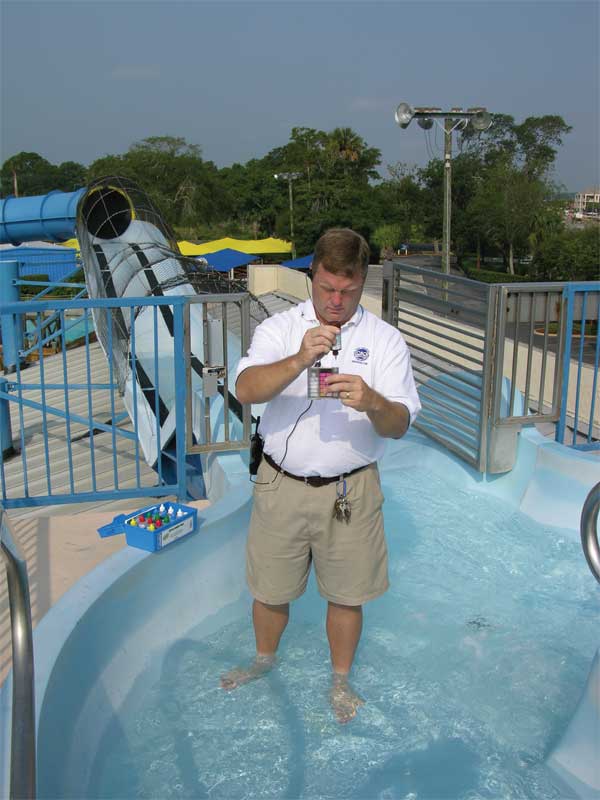 Pool service professional checking water quality