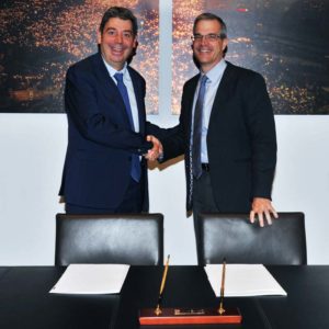 Fluidra and Zodiac executives shake hands and announce the merger of the two companies.