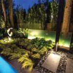 Frosted glass panels in the garden are illuminated with strip lights, which seem to glow.