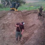 Fine-tuning the natural swimming pool (NSP) excavation is done by hand.