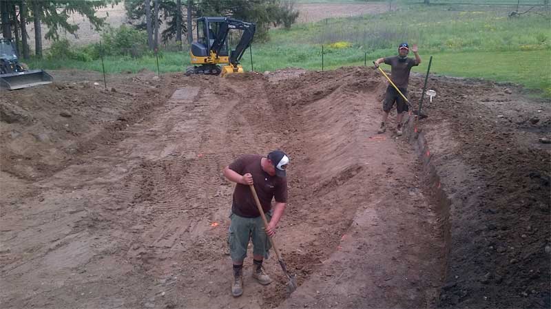 Fine-tuning the natural swimming pool (NSP) excavation is done by hand.