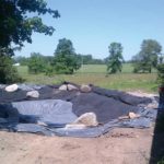 Geotextile fabric is placed over top of the liner to provide protection.