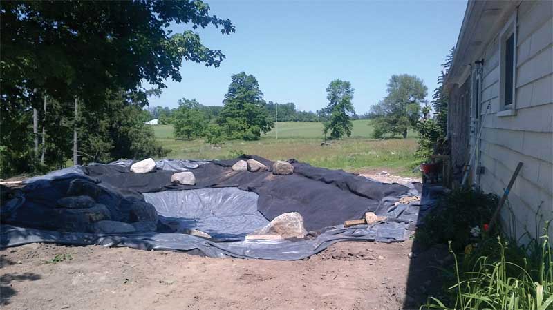 Geotextile fabric is placed over top of the liner to provide protection.