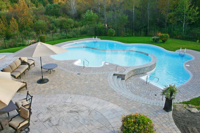 This vanishing edge pool patio has both honed limestone pavers and interlock concrete pavers.