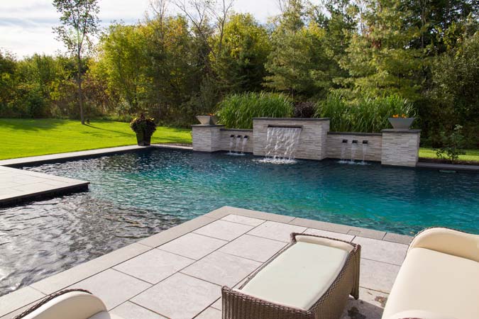 The clean, crisp lines of this natural stone patio mimic the architecture of the residence.