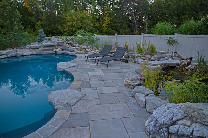 Split sandstone imported from India was used as the paving stone for this pool patio.