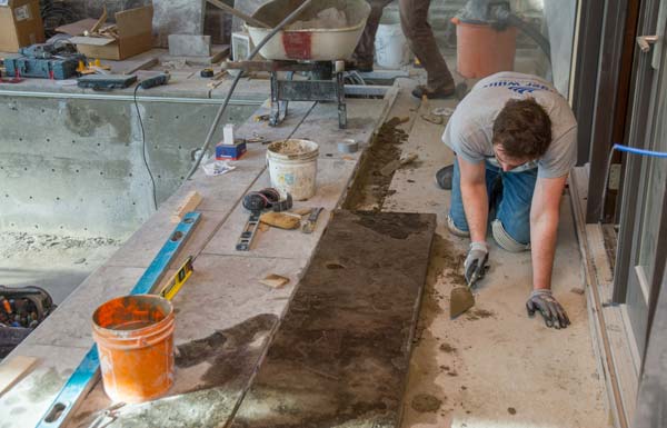 Installation of the large rectangular slabs of flamed Eramosa limestone.