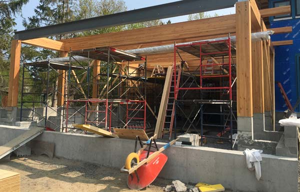 Large laminated pine beams and their coordinating support posts from western Canada support the entire pool room structure and roof.