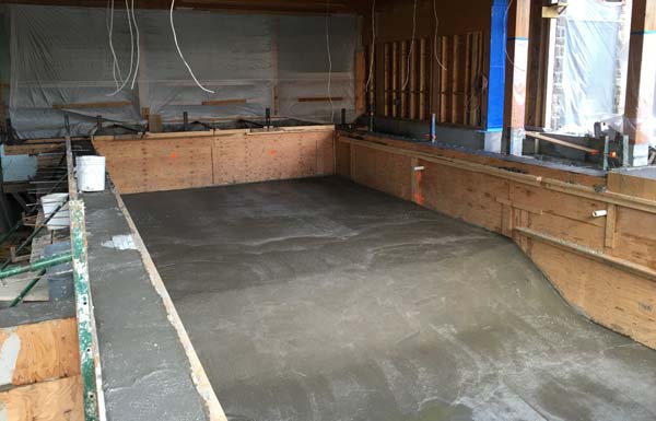 With the forming complete, pouring of the walls, floor and other concrete components of the pool and hot tub were completed in one single concrete pour.