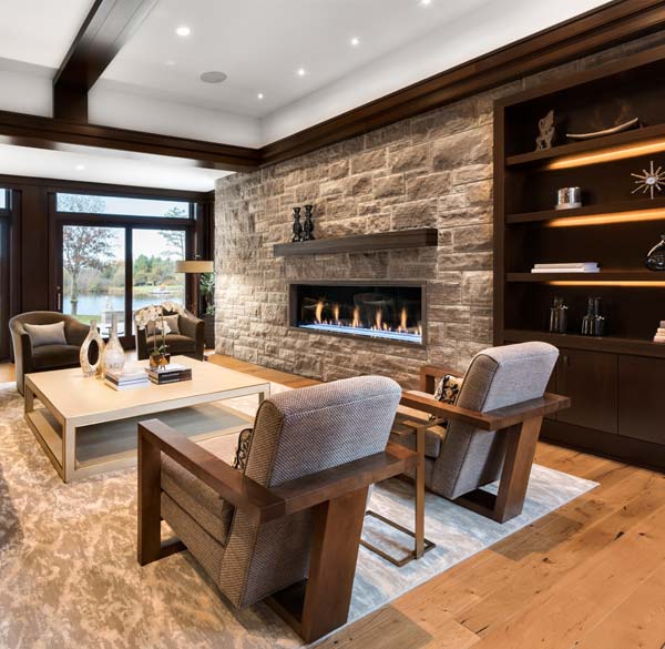 The design of the living room and its fireplace incorporates the same Eramosa limestone used to veneer sections of the home’s exterior.