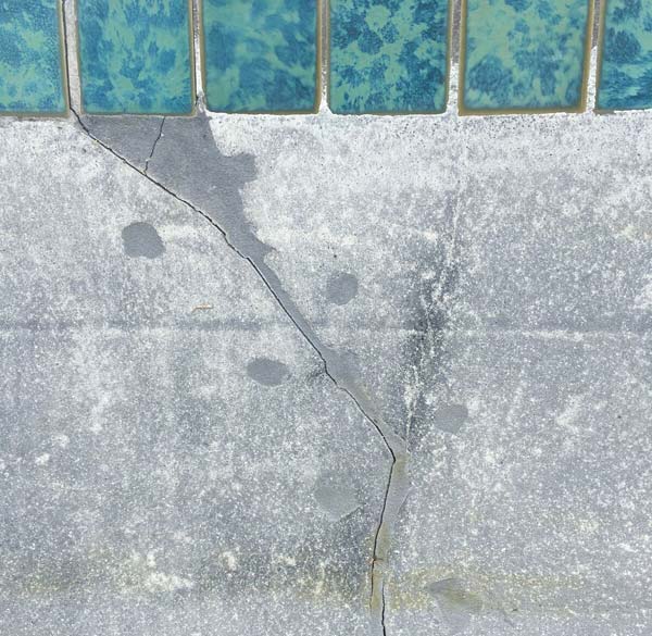 This structural crack in the pool wall starts at the waterline tile.