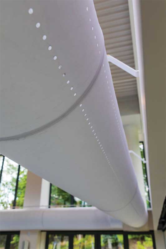 Two 609-mm (24-in.) white fabric duct lines are mounted 3 m  (10 ft) high and nearly encircle the entire pool perimeter. 