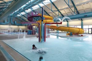 Water or spray features effectively mix water and air in an indoor pool.