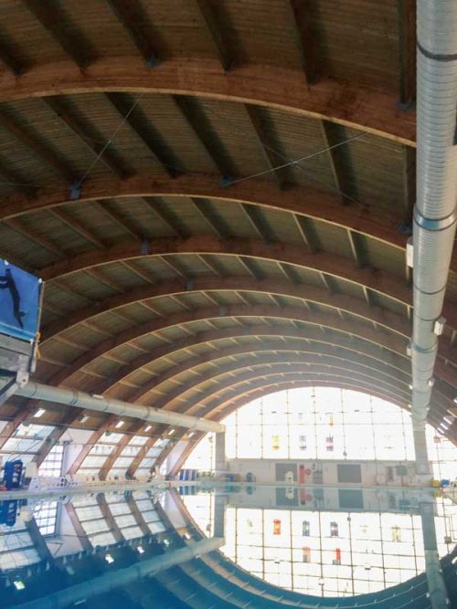 Ducts run along the ceiling on either side of the combat training pool, providing ample diffusion of supply air with some openings pointed up along the ceiling and others directing flow down into the breathing zone.