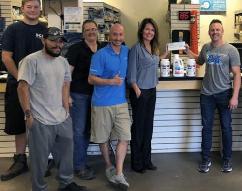 Matthew Barclay owner of Blue Moose Pools receiving his prize money at the SCP Distributors LLC branch in Phoenix, Ariz.