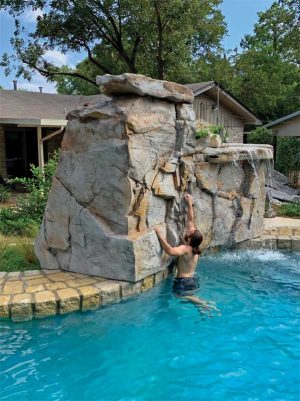 Climbing walls with built-in water features make perfect visual barriers and also provide loads of fun for pool users.