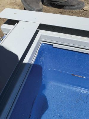 As the corners of most fibreglass pools have a radius, one trick some installers use is notching out the lip in the coping that was originally designed for a vinyl liner bead receiver.