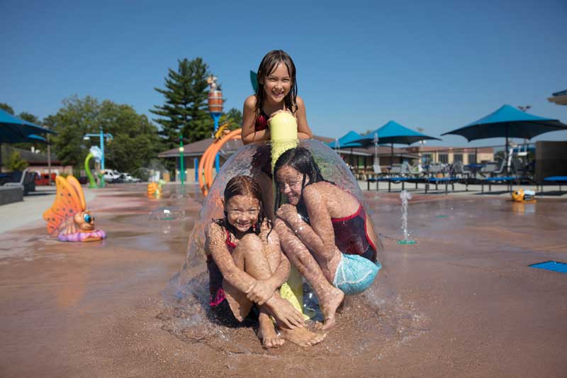 Kids can either play from outside the mushroom of water or sit under the dome of sprays.