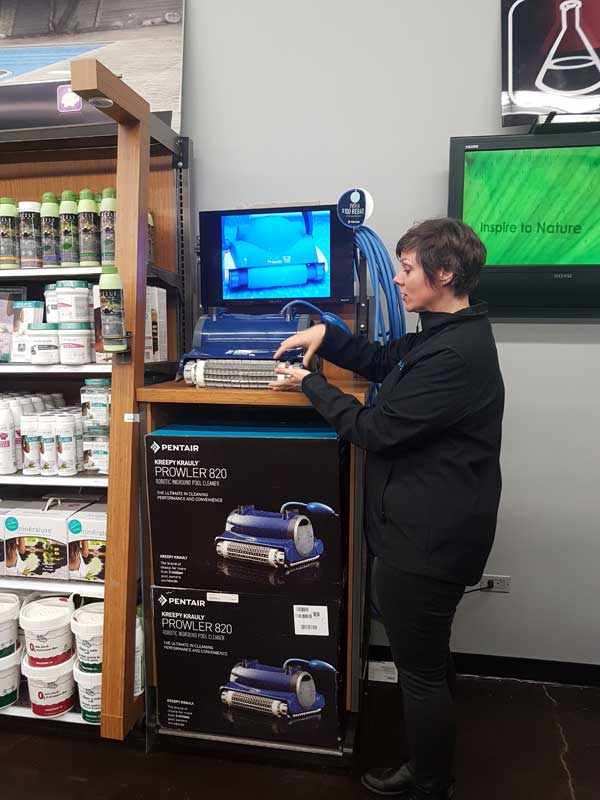 A robotic cleaner display near the water testing station that uses video to show customers how the cleaner works is a strategic sales display.