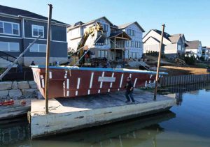 This fiberglass pool was picked up off the barge using an excavator and placed directly into the backyard directly.