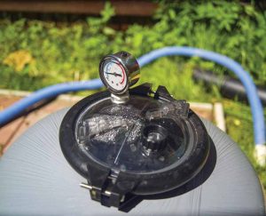 A quick examination of the filter pressure gauge reading above 20 PSI or low flow coming from the returns can be indicators of a filter needing service.