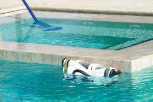 Photo showing pool cleaning equipment in swimming pools.