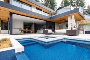 The design opens the interiors of the house to maximize views of the pool, while also serving as an entrance to the pool.