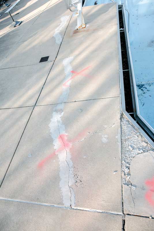 When the pool was emptied, water flowing across the damaged concrete decking was found re-entering the pool between the gutter and the shell.