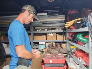 A man using mobile technology in running a pool business.