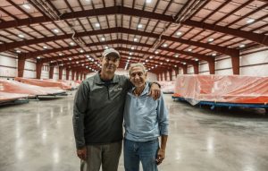 Jason Hughes (left), founder of River Pools and now the president of River Pools Franchising, and Bill Khamis (right), founder and chief financing officer (CFO) of Thursday Pools LLC pose together.