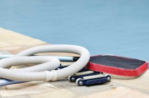 Skimming leaves, brushing, and vacuuming surfaces are all essential to maintaining a clean pool.