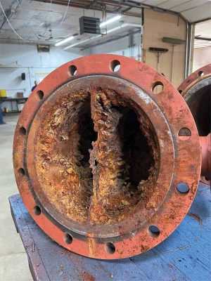 Corrosion and mineral deposits are obvious in this steel shell-and-tube heat exchanger.