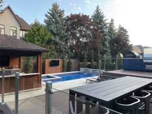 To elevate the space, the client wanted to add a pavilion with storage, a large outdoor dining area, a complete outdoor kitchen, and a hot tub.