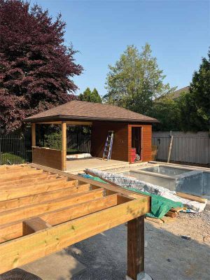 Once the pavilion floor was completed, carpenters on the Timber Craft team were able to start their portion of the project. The pavilion was erected with a hip-style roof, and finished with Maibec, in Muskoka Brown.