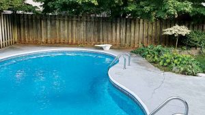 The pool’s original vinyl liner had a conventional design, featuring a square-tile border and a simple blue and grey colour scheme.