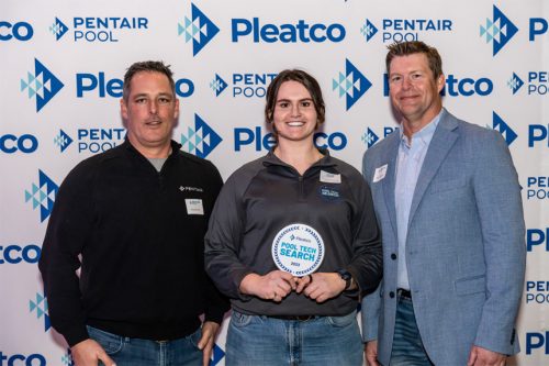 Three people stand proudly at the Pleatco Pool Tech Search event, with one holding an award.