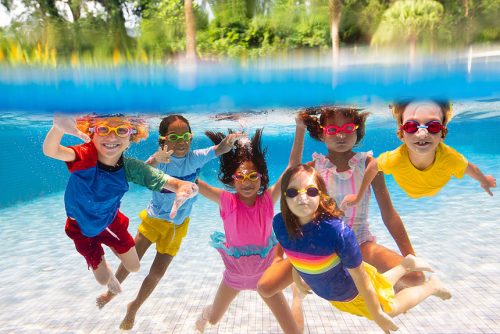 kids in swimsuits inside the pool