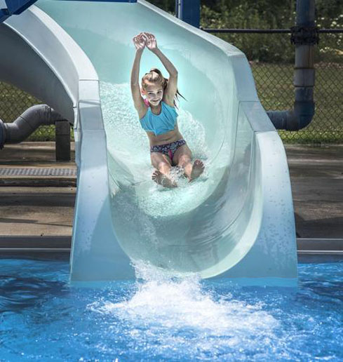 girl in swimsuit going down a waterslide