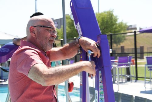 man in a red shirt working on equipment