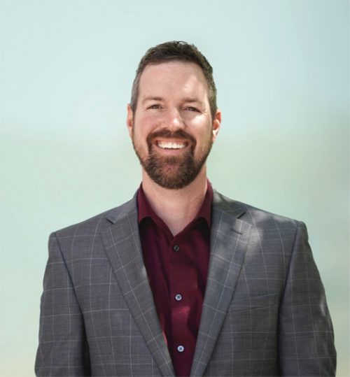 headshot of a man smiling at the camera