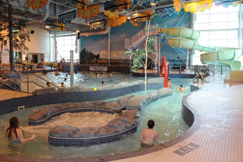 interior of an aquatic centre's pool with swimmiers