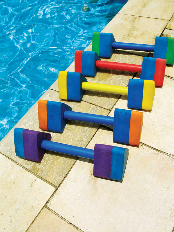 Water aerobic dumbbells in green, red, yellow, orange, and purple, lined up on the poolside deck.